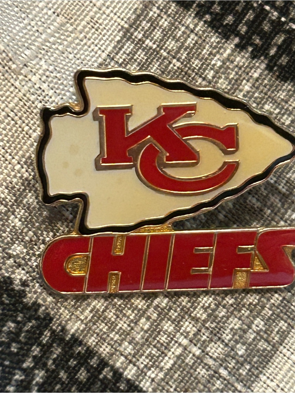 collectible Kansas City Chiefs logo pin featuring the iconic arrowhead design.